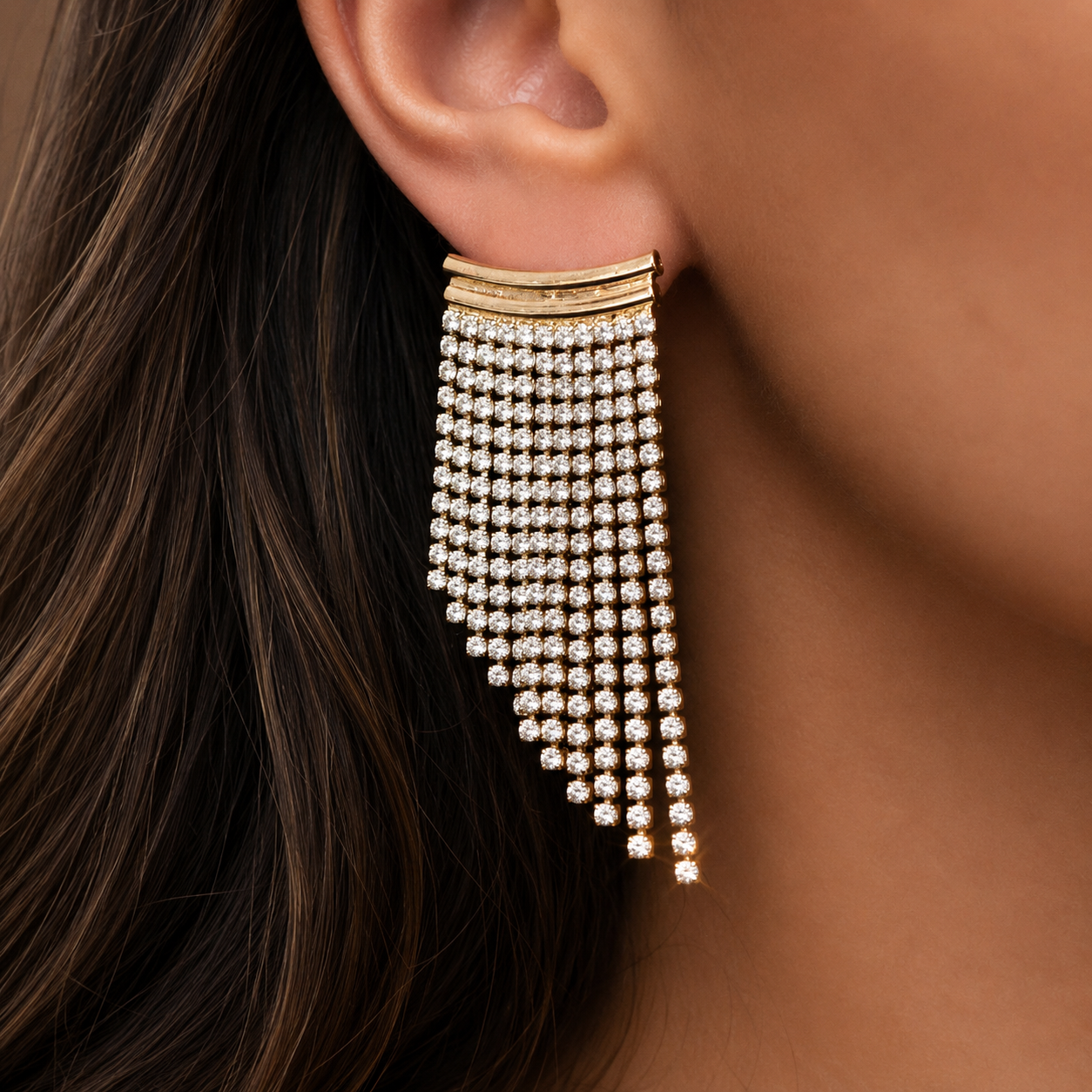 Valentina-Rose model wearing a gold and crystal fringe statement earring.