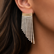 Valentina-Rose model wearing a gold and crystal fringe statement earring.