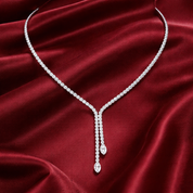 Lariat tennis necklace on a red satin background