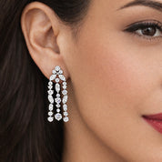 Close-up of a woman wearing a sparkling chandelier earring.
