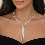 Tennis necklace on a model against a neutral background