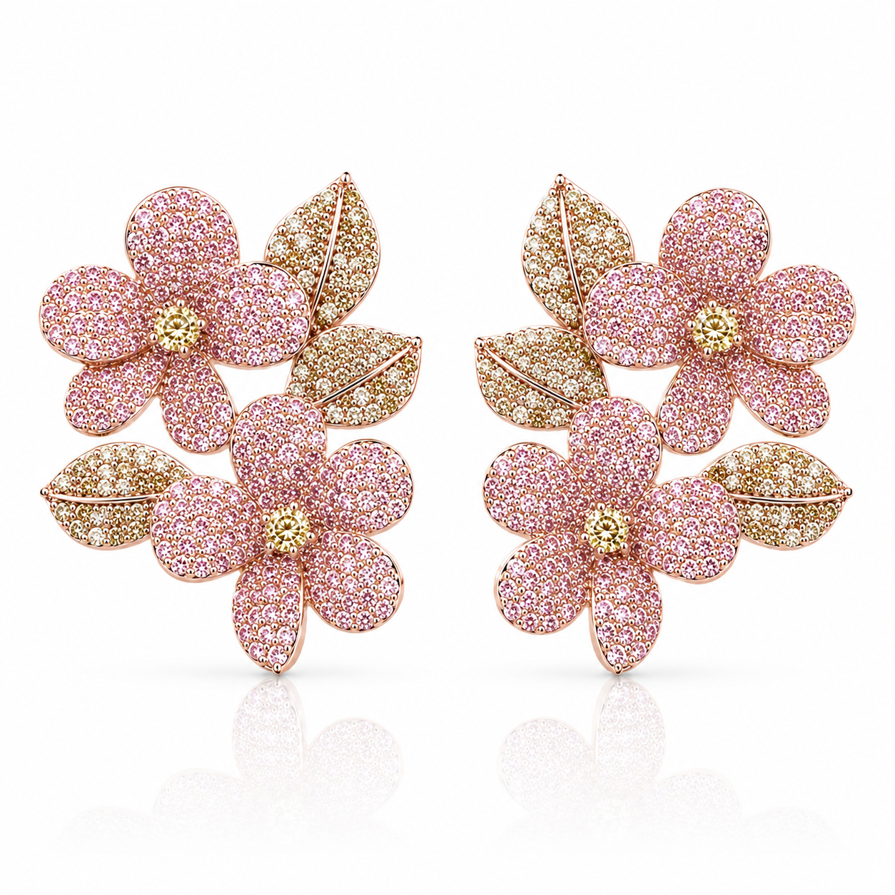A pair of Valentina-Rose floral stud earrings featuring pink pavé-set flower petals with gold-toned leaf accents and gold centers, displayed on a clean white background with a soft reflection.