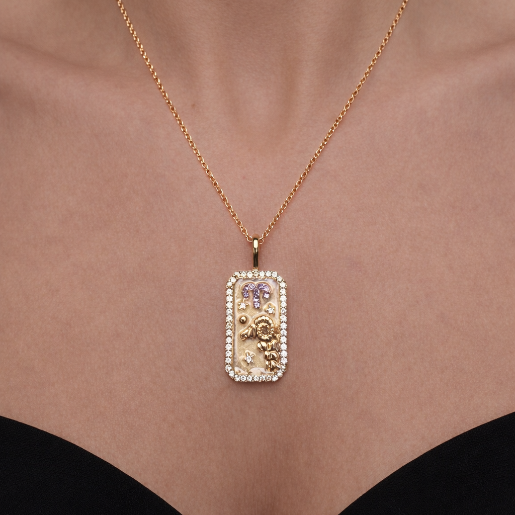 Gold Aries zodiac necklace with a rectangular pendant on a person's neck against a neutral background