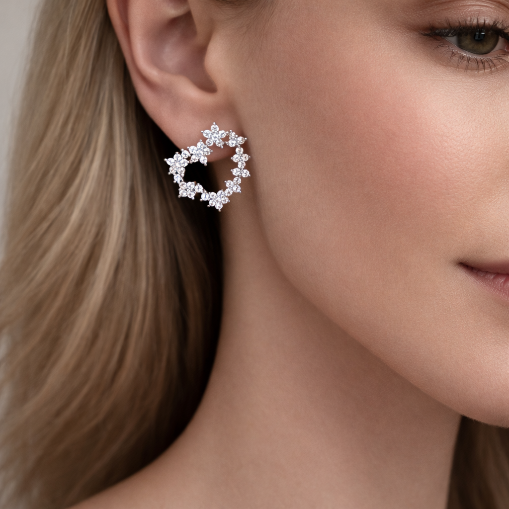 Model wearing silver open heart flower statement earrings with crystal clusters, luxury jewellery UK