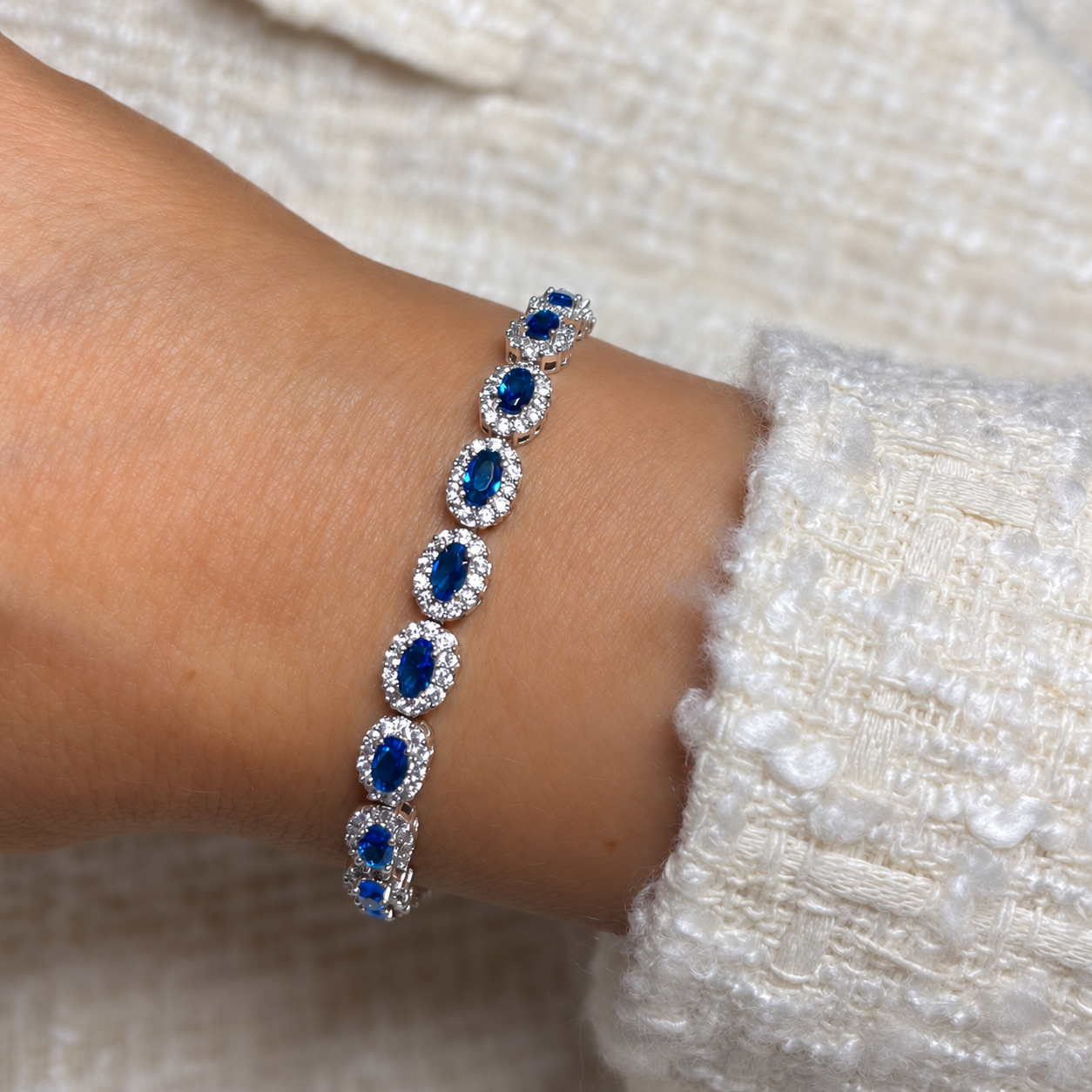 Model wearing Opulence Oval Cut Halo Tennis Bracelet in Sapphire Blue and Silver | Valentina-Rose Jewellery