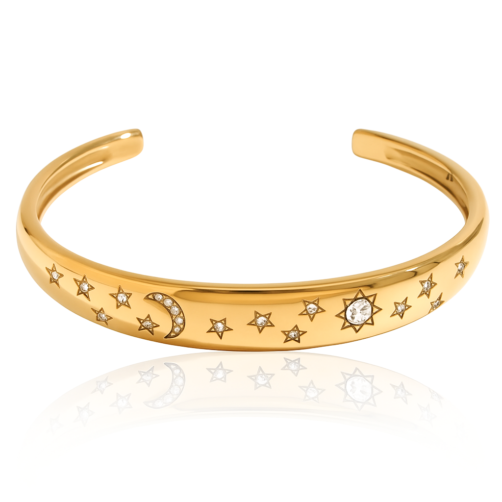 Close-up of an open cuff bangle bracelet plated in 18k gold stainless steel, featuring a celestial design with sparkling cubic zirconia crystals arranged as stars, a crescent moon, and a sunburst. The bracelet’s polished surface shines with a shimmering night sky effect. Lightweight and durable, designed to be waterproof, tarnish-free, and hypoallergenic—perfect for everyday wear or special occasions.