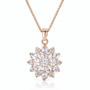 Rose gold necklace with a sparkling cluster marquise pendant on a white background