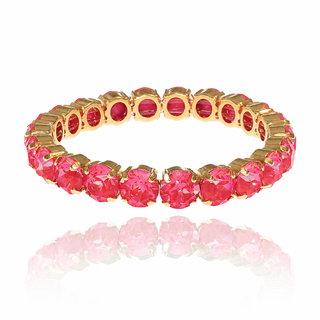 Gold bracelet with poppy red Swarovski gemstones on a white background