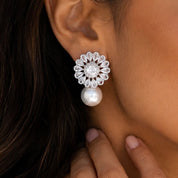 Model wearing a floral cz earring with a pearl accent.