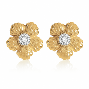 Gold flower-shaped earrings with clear gemstones on a white background