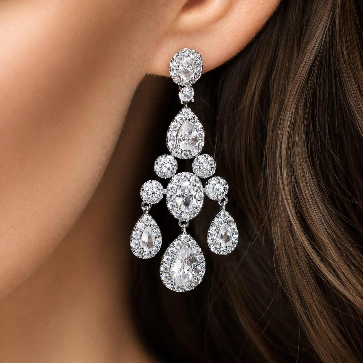 Model wearing a sparkling silver chandelier statement earring. 