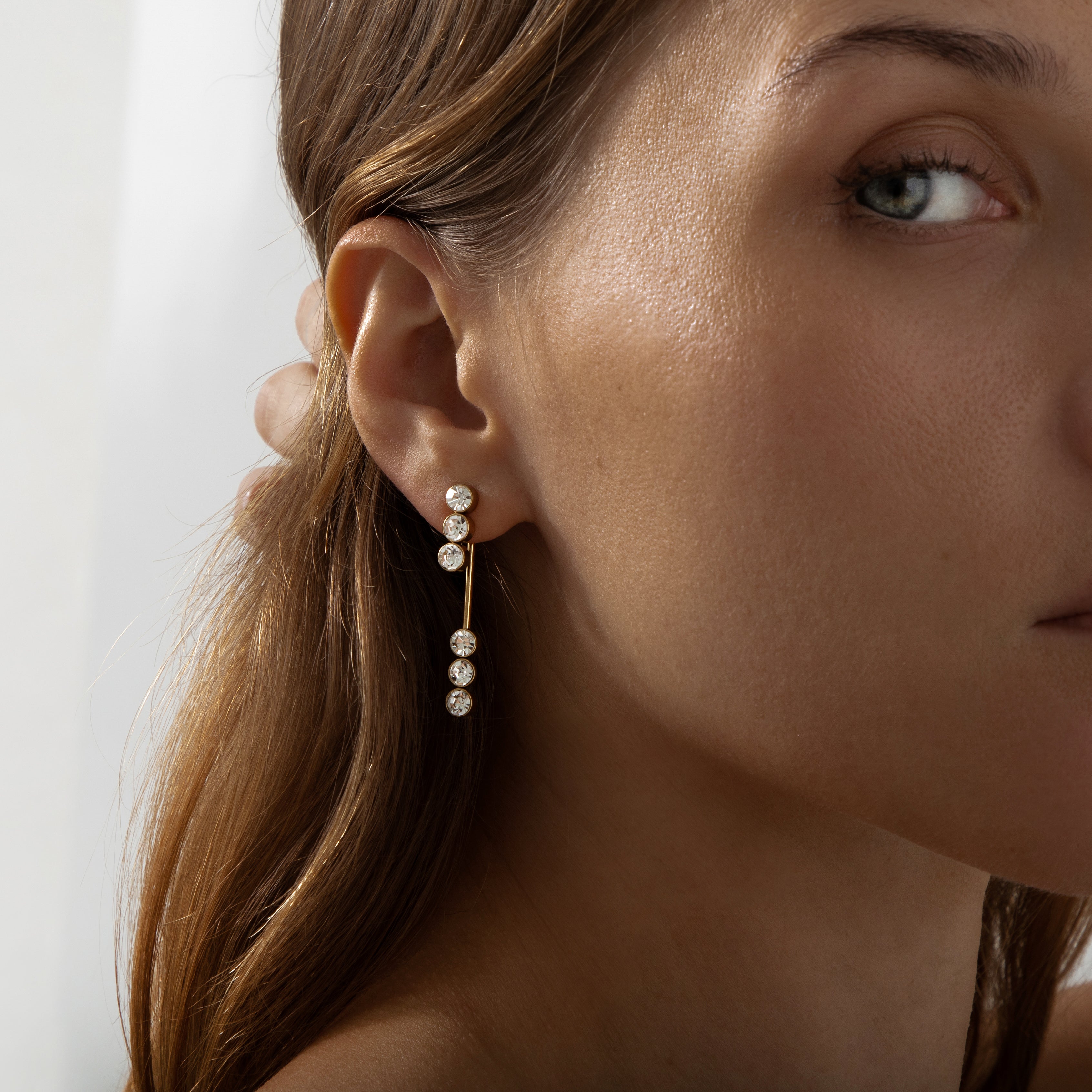 Gold front-to-back drop earrings with a minimalist linear design and high-polish finish, part of the Illuminate Collection by Valentina Rose.