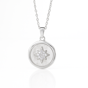 Silver necklace with a star-shaped pendant on a white background