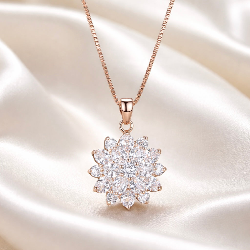 Rose gold necklace with a marquise cluster pendant on a satin background