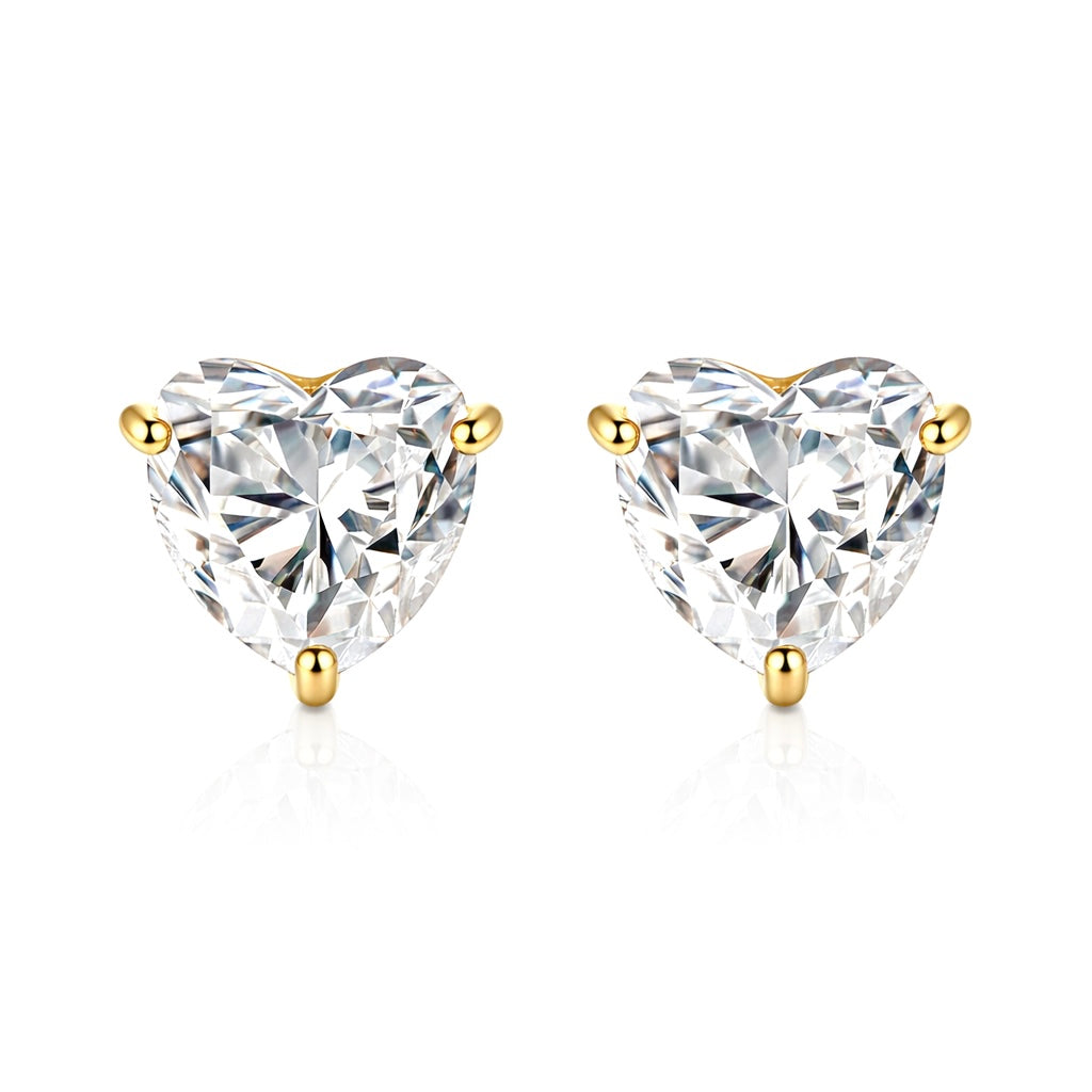Heart-shaped diamond stud earrings with gold prongs on a white background