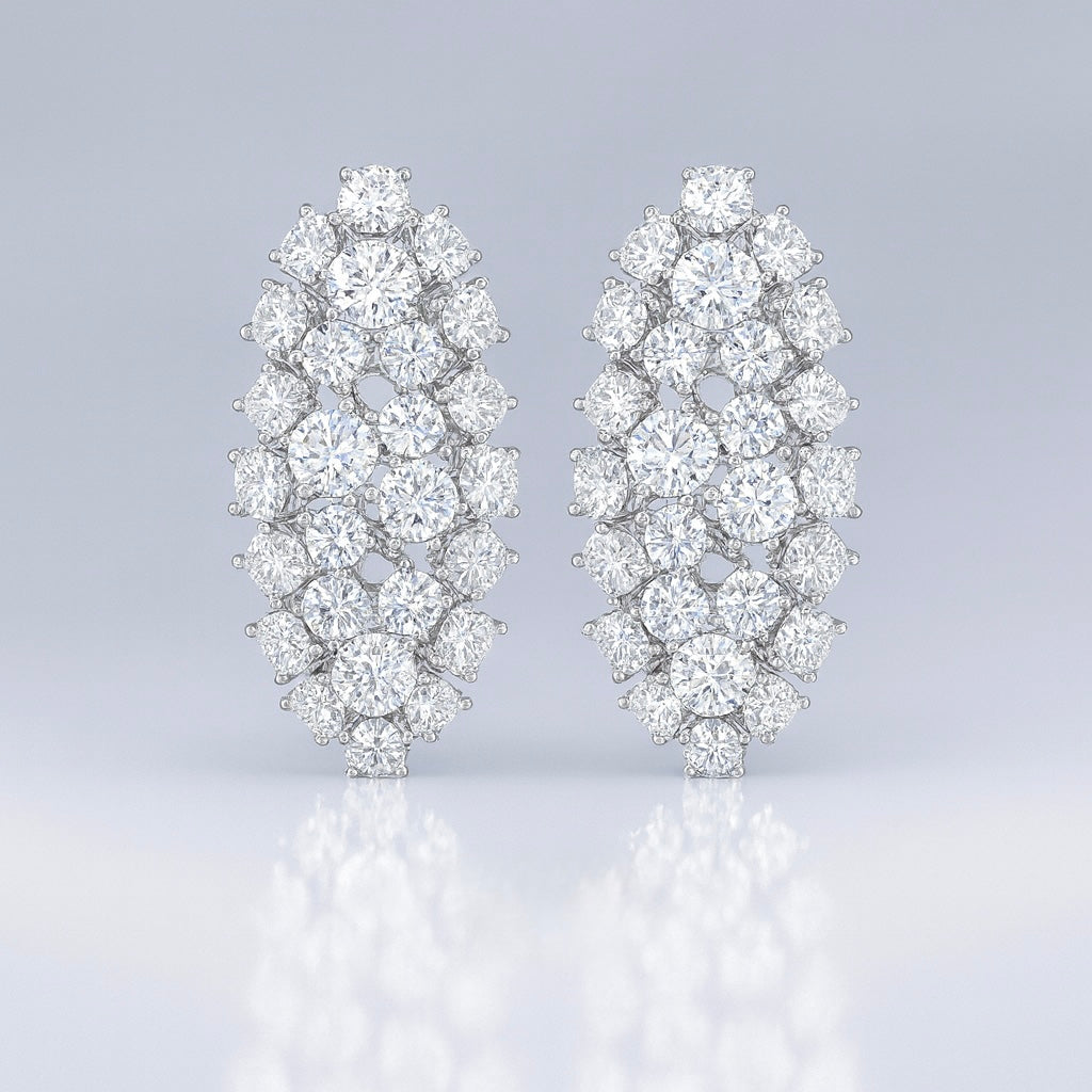 Pair of diamond like oval icy earrings on a light gray background