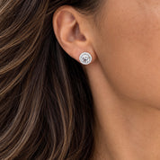 Model wearing round sterling silver halo stud earrings with brilliant clear cubic zirconia – Valentina-Rose