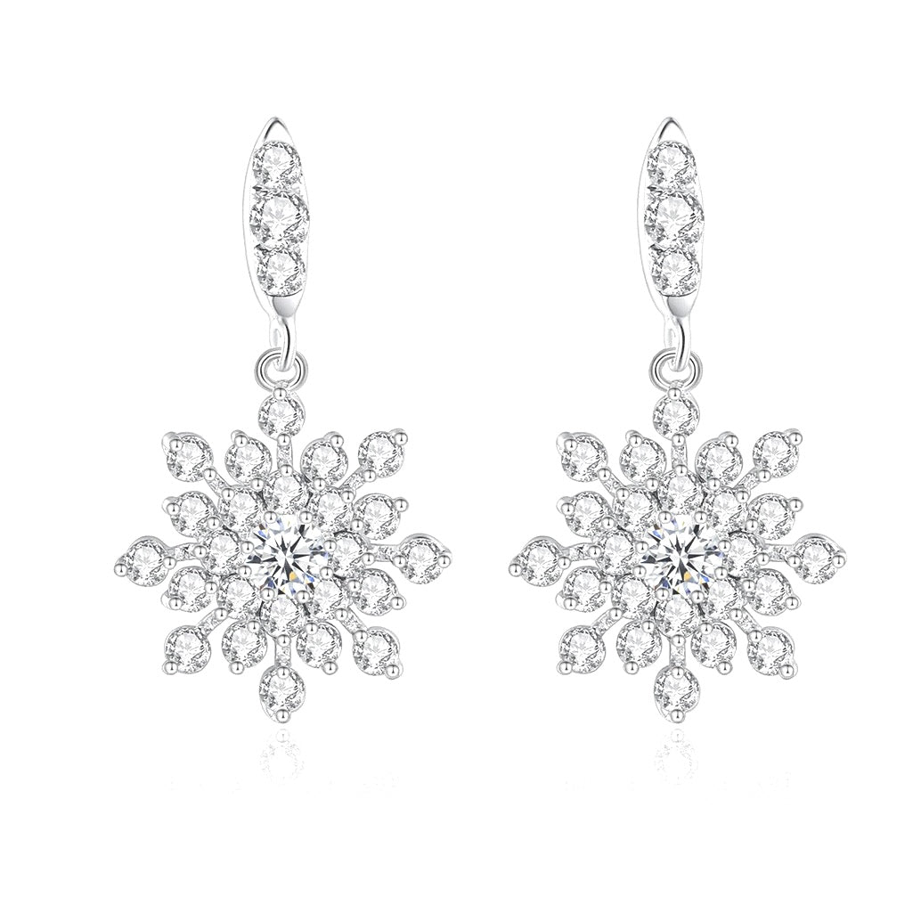Snowflake-shaped earrings with clear gemstones on a white background