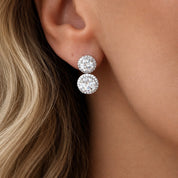 Model wearing silver sparkling stud halo drop earrings 