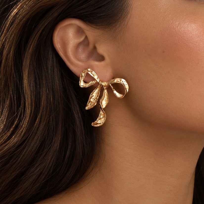 Model wearing Ribbon Twist Hammered Bow Earrings in Gold | Valentina-Rose Jewellery