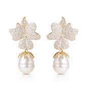 Pair of earrings with floral designs and pearl-like bottoms on a white background