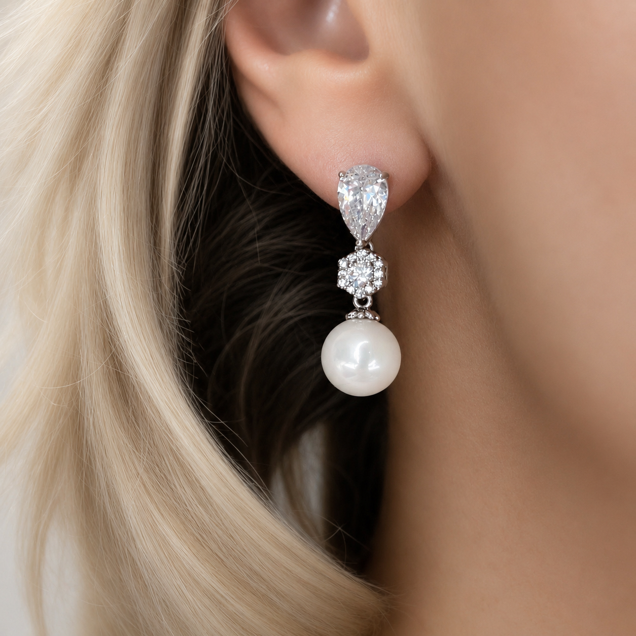 Pearl drop earring worn by a model 
