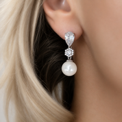 Pearl drop earring worn by a model 