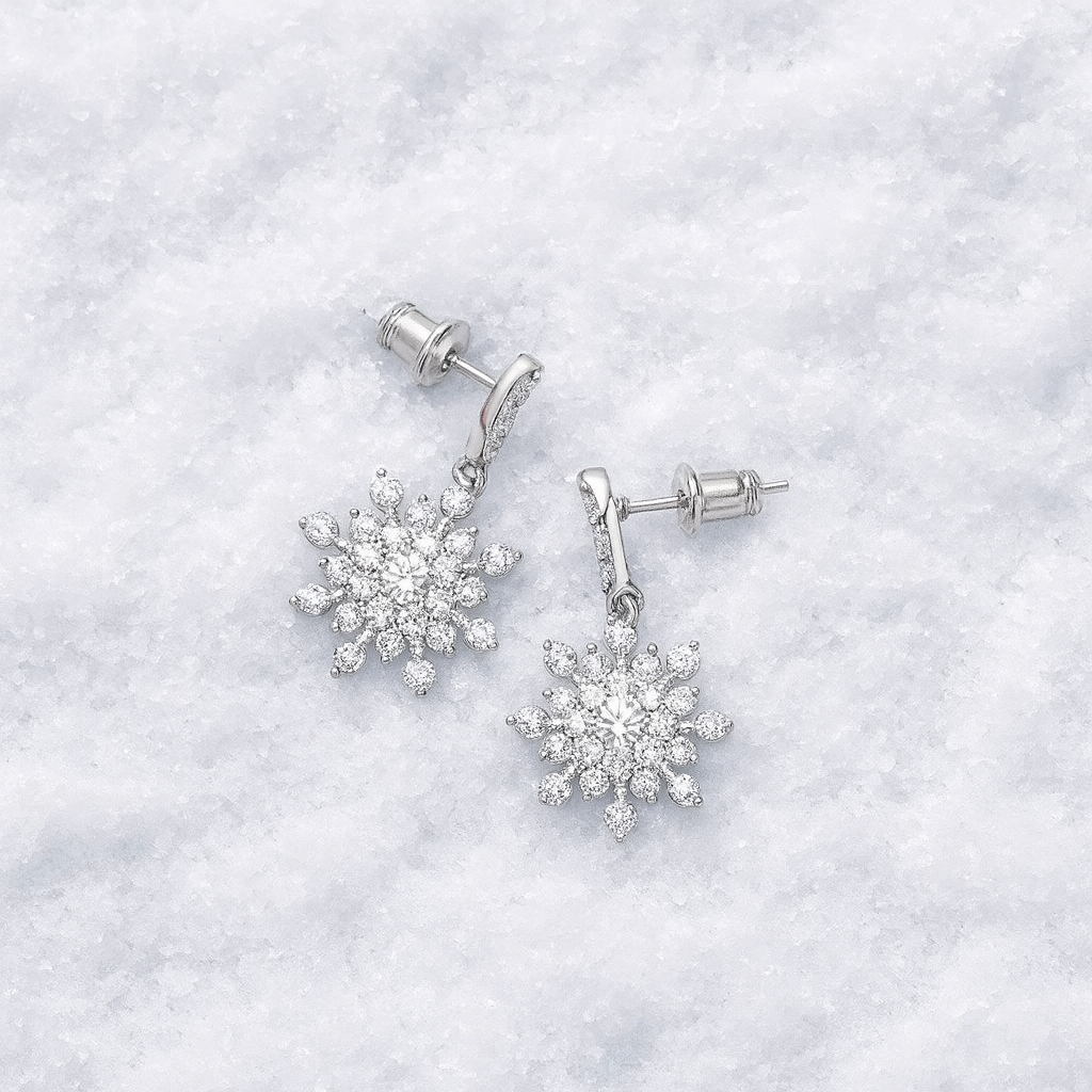 Snowflake-shaped earrings on a white textured background