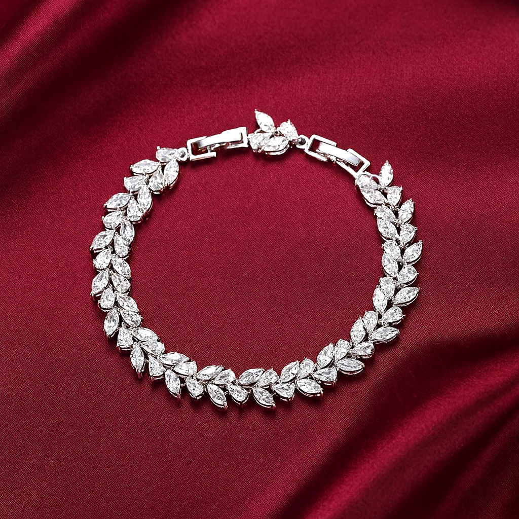 Silver vine bracelet with leaf-shaped diamonds on a red fabric background