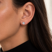 Model wearing Secret Halo silver stud earring with brilliant round-cut stone in a polished 925 sterling silver setting