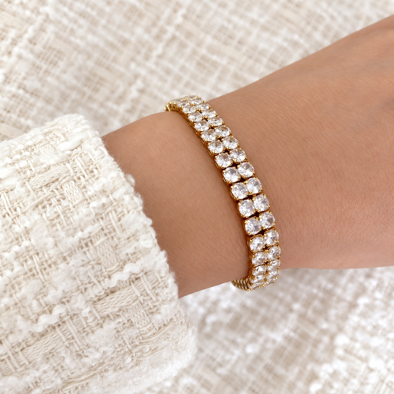 Model wearing gold double-row tennis bracelet with brilliant white stones by Valentina Rose