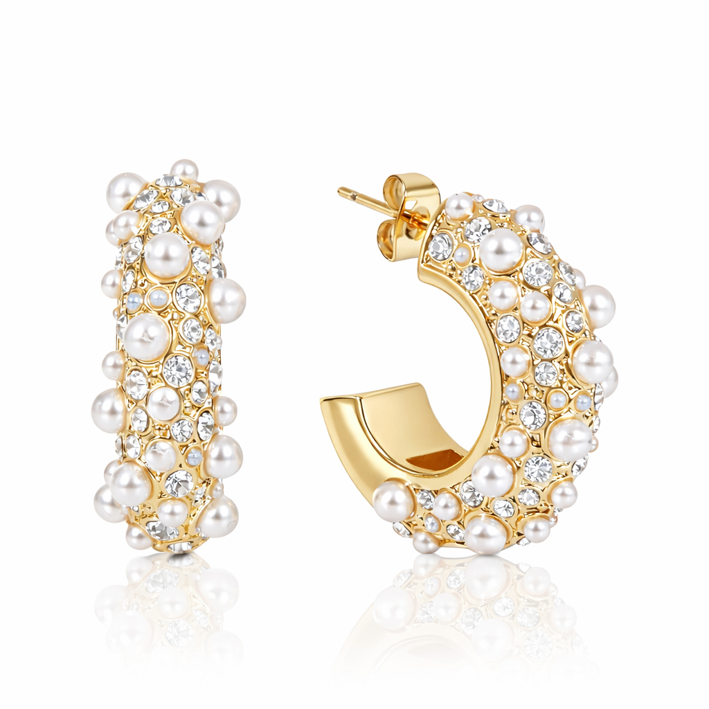 Gold hoop earrings with pearls and crystals on a white background