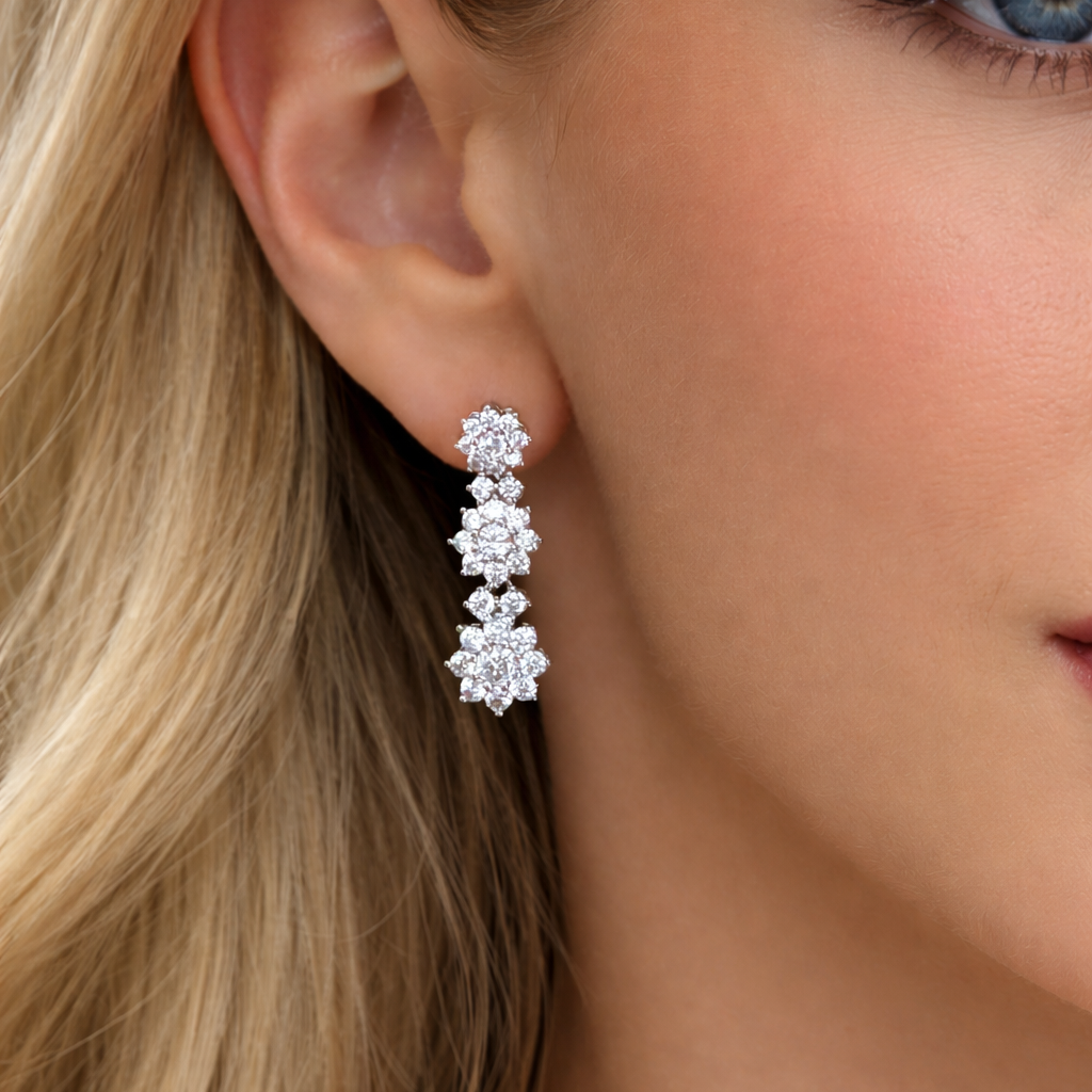 Close-up of a woman wearing a diamond earring with blonde hair and blue eyes.