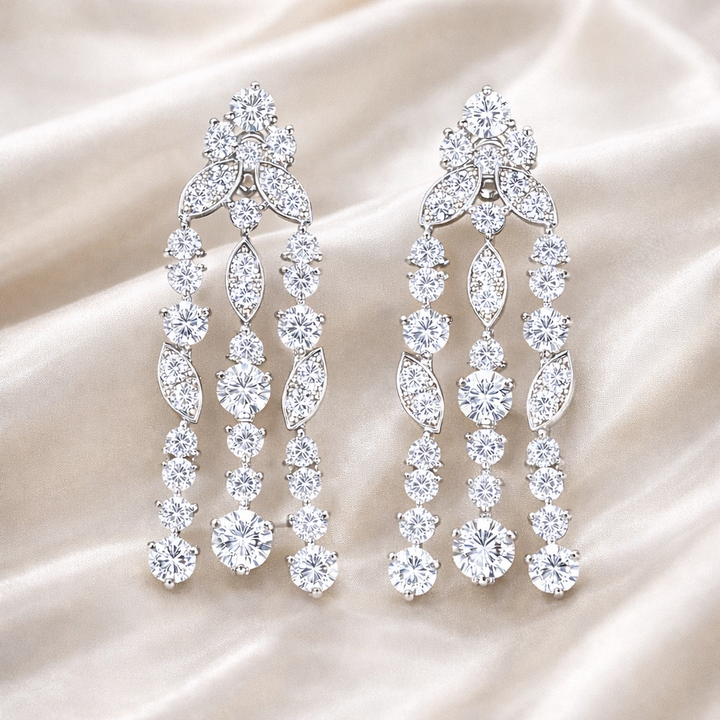 Pair of silver chandelier earrings on a beige fabric background