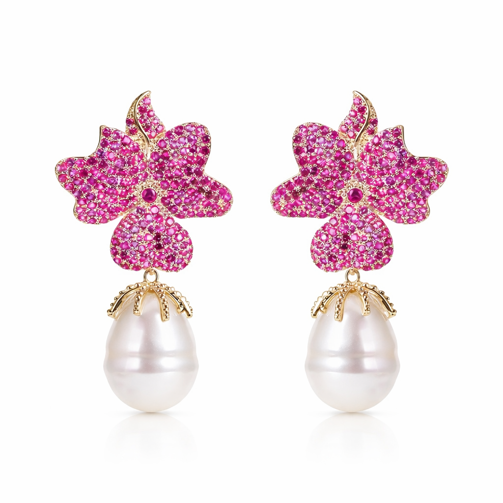 Pair of earrings with pink floral top and pearl bottom on a white background