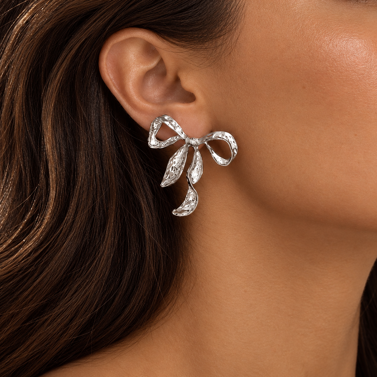 Model wearing Ribbon Twist Hammered Bow Earrings in Silver | Valentina-Rose Jewellery