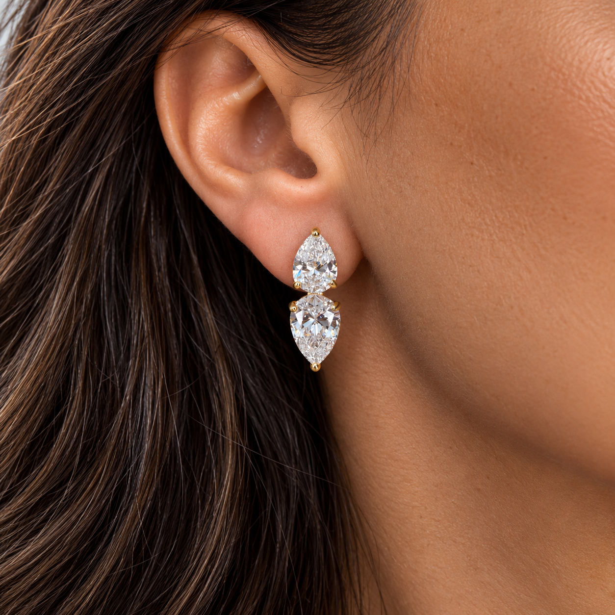 Model wearing gold double pear-cut statement stud earrings with clear cubic zirconia – Valentina-Rose