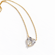 Close-up of gold heart necklace featuring a brilliant clear heart-cut cubic zirconia stone in a delicate gold setting – Valentina-Rose